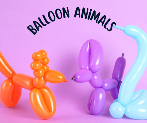 Balloon animals - an orange dog, a purple dog and a light blue swan