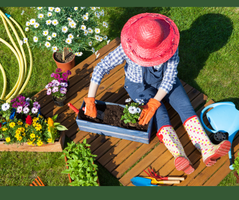 Teen sitting on a small desk with garden plants and tools around them