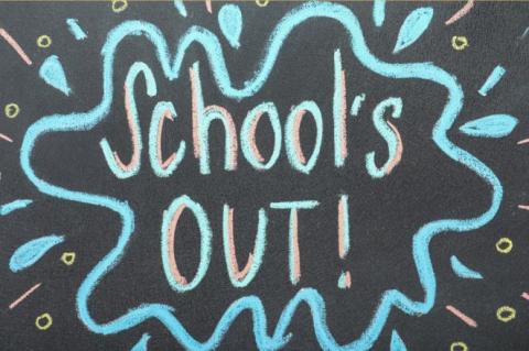 Writing on chalkboard saying "School's Out!"